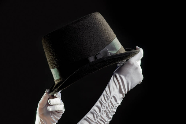 Hand gestures. Showman shows disappearing tricks in a hat, white gloves and black top hat, - Valokuva, kuva