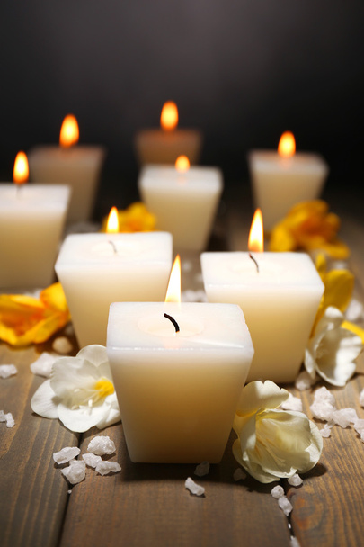 Beautiful candles with flowers on wooden background - Фото, изображение