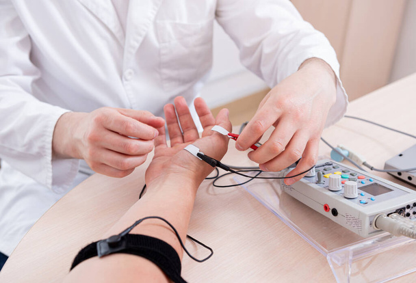 Patient nerves testing using electromyography at medical center - Photo, Image