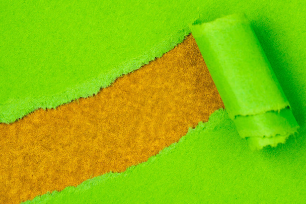Green paper torn to reveal golden background  ideal for your text - Foto, Bild