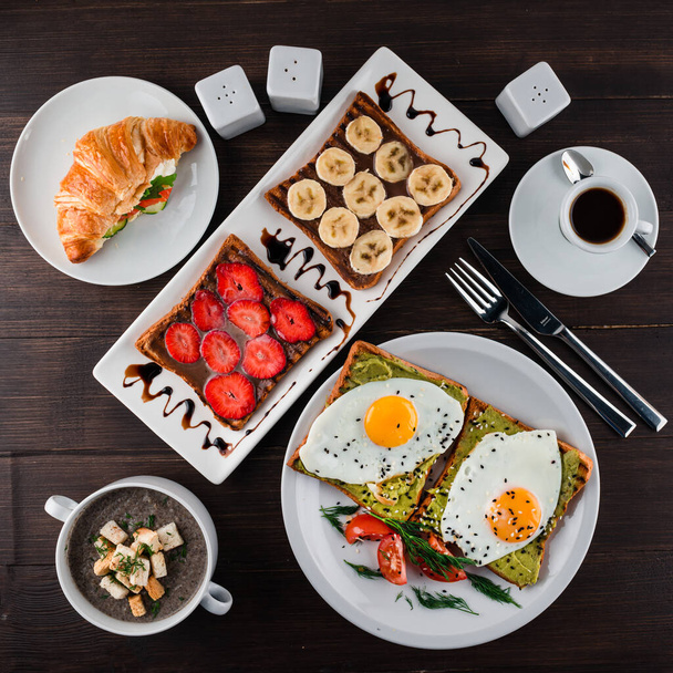 set breakfast egg sandwiches, croissants with juice. products for a delicious European Breakfast Scrambled eggs, croissants and orange juice. Balanced diet top view, flat lay - 写真・画像