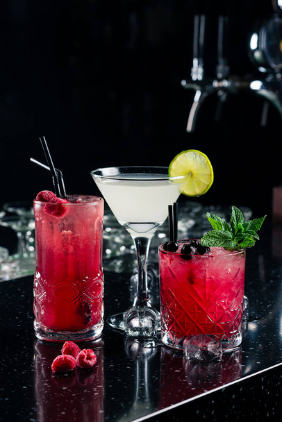 three classic cocktails on the bar in a nightclub, Set of three healthy nonalcoholic cocktails berries, Three tropical mixed drinks - 写真・画像