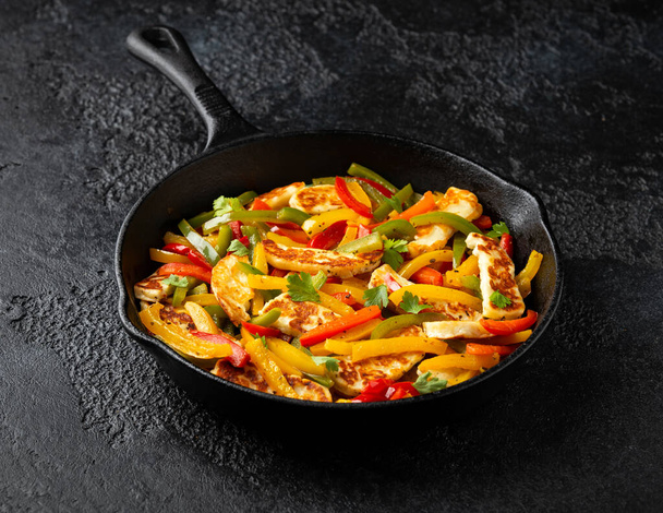 Tasty Halloumi cheese Fajitas with mix pepper in iron cast pan. Healthy food. - Photo, Image