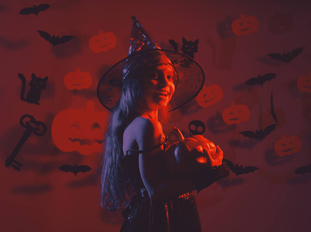 Happy Halloween Cute little witch with a big pumpkin - Valokuva, kuva