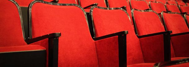 Modern cinema hall empty and red comfortable seats, movie theater seats or chair - Foto, immagini