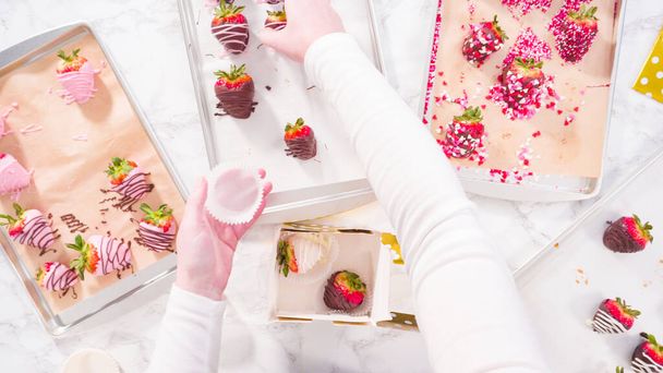 Flat lay. Step by step. Packing gourmet chocolate dipped strawberries into a gift box. - Photo, Image