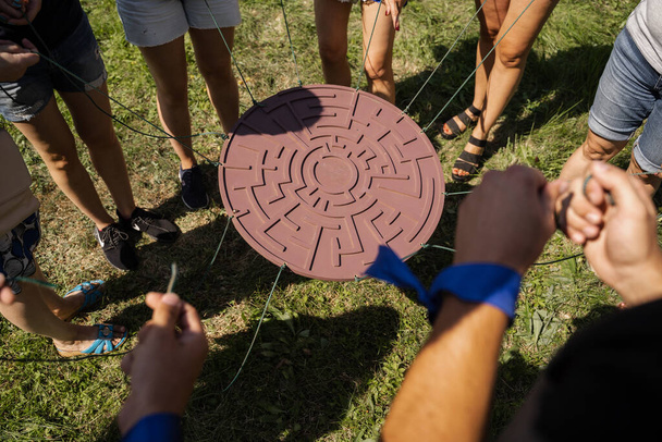 Teambuilding game for group of people for getting team spirit and increase friendship for colleagues. Labyrinth game for group of people. - Photo, Image
