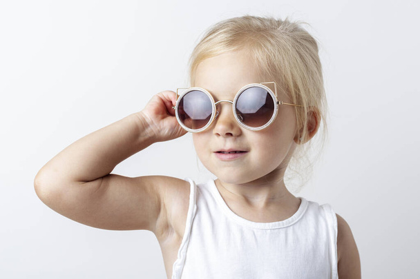 Gyönyörű szőke lány napszemüveg egy könnyű stúdió háttér.  - Fotó, kép