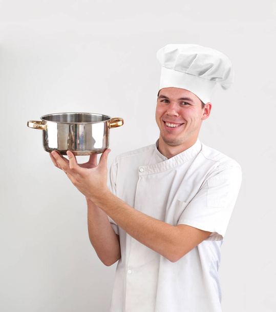 happy caucasian chef holding empty saucepan isolated on white background. smiley face. - Foto, immagini