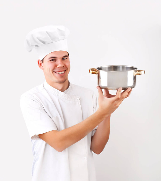 happy caucasian chef holding empty saucepan isolated on white background. smiley face. - Zdjęcie, obraz