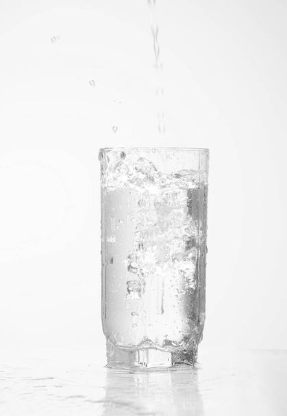  pouring water pouring into a glass isolated  - Foto, immagini