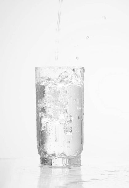  pouring water pouring into a glass isolated  - Фото, зображення