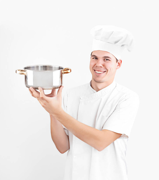 happy caucasian chef holding empty saucepan isolated on white background. smiley face. - Fotó, kép