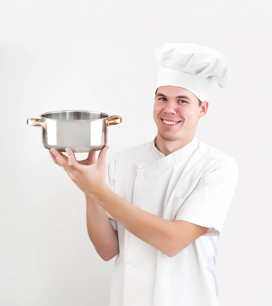 happy caucasian chef holding empty saucepan isolated on white background. smiley face. - Фото, изображение