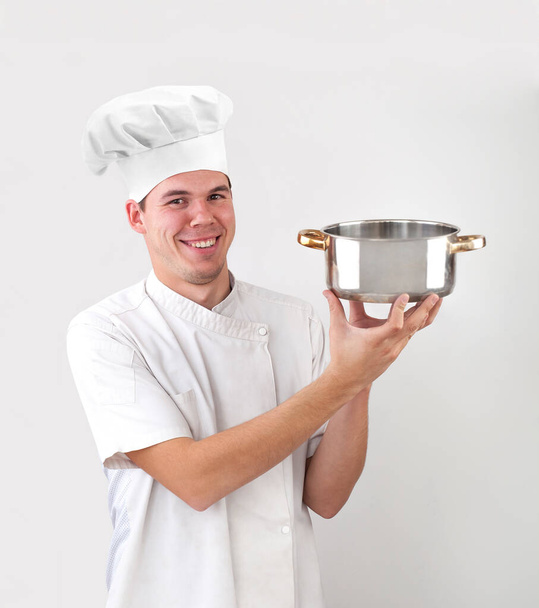 happy caucasian chef holding empty saucepan isolated on white background. smiley face. - Fotografie, Obrázek