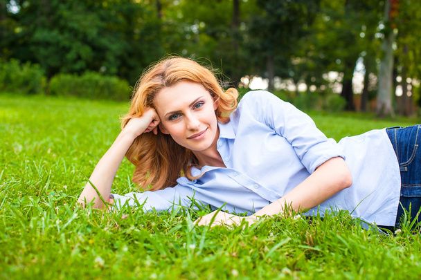beautiful young woman relaxing in grass - Fotó, kép