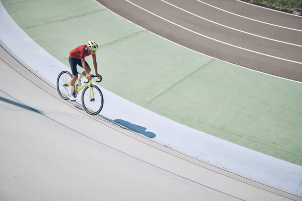 Top view of man in sports clothing cycling on track outdoors - Fotoğraf, Görsel