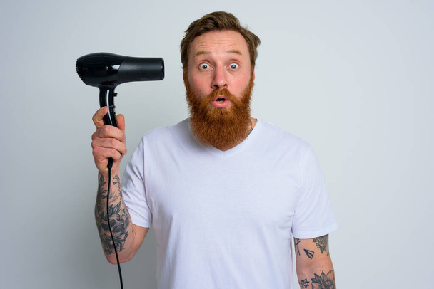 Homem incrível com barba brincar com secadores de cabelo uma pistola - Foto, Imagem