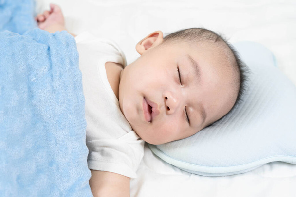 Sleeping baby, selective focus portrait of charming newborn  on comfortable bed - Фото, изображение