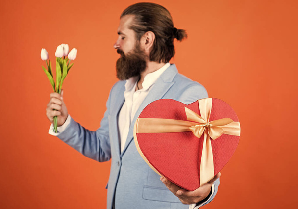 man with beautiful spring flowers. Fresh tulips bouquet. man holding bouquet of tulips. happy valentines day. man share tulip flowers. love present for her. celebrate the holiday. True love - Foto, Bild