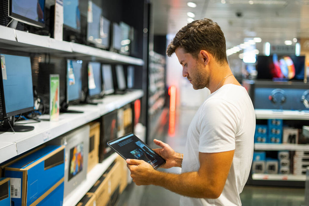 Man choosing monitor in shop - Photo, Image