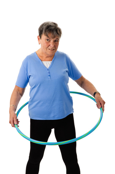Senior woman exercising with hula-hoop - Fotografie, Obrázek