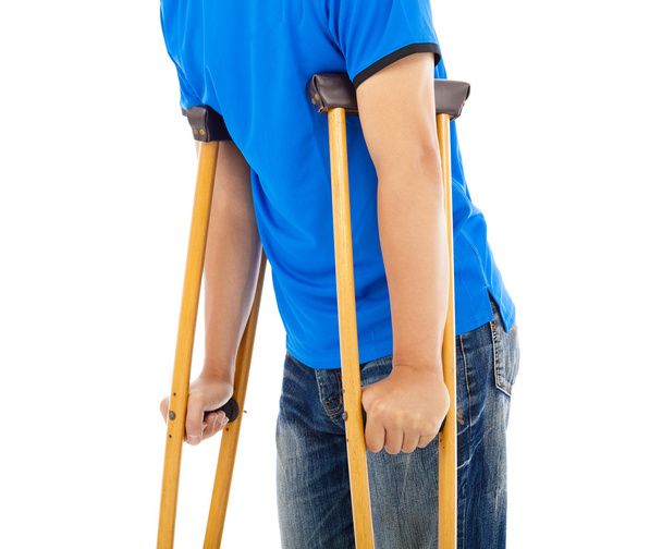 close up of young man on crutches. white background - Photo, image