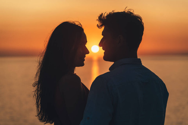 The two happy people standing on the beautiful sunset background - Photo, Image