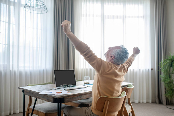 Gray-haired man in casual clothes working from home - Photo, image
