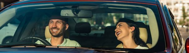 The smiling man and woman sitting in the car - Photo, image