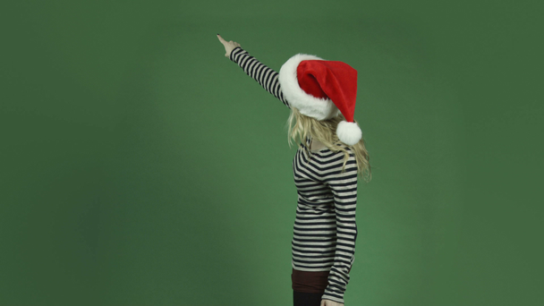 Woman in christmas santa pointing - Footage, Video