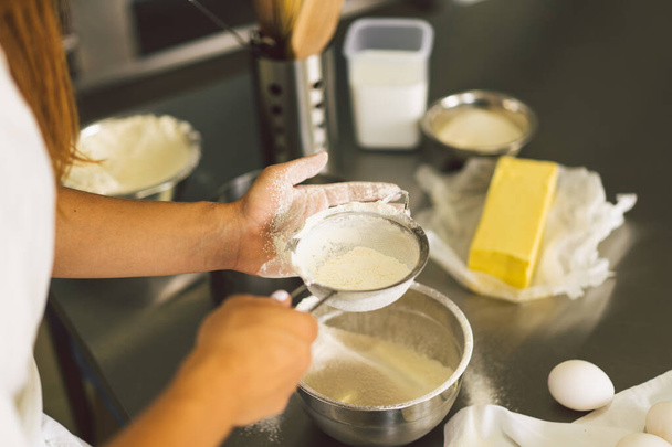 Hands working with dough preparation recipe bread, pizza or pie making ingridients. Cooking cakes. - Fotó, kép