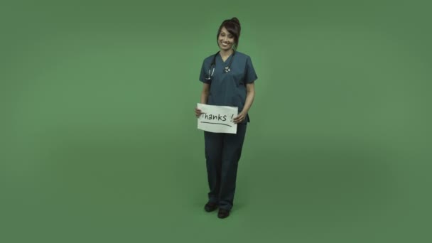 Médico femenino con signo de agradecimiento
 - Imágenes, Vídeo
