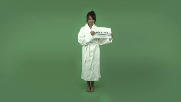 Woman in bathrobe with hire me sign - Кадри, відео