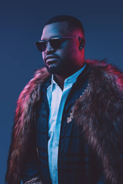 African businessman dressed in fur coat and suit - Fotografie, Obrázek