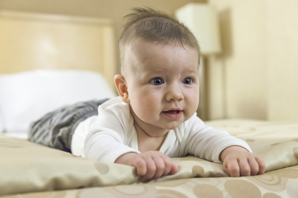 Baby boy playing on a bed - Photo, Image