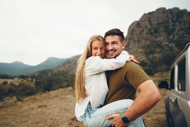 Young couple is on romantic trip to the mountains by car - Фото, зображення
