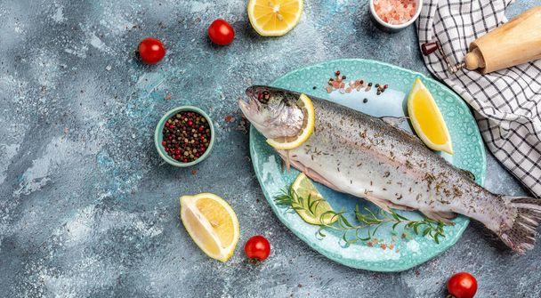 Rainbow trout Raw fish with lemon. Healthy eating concept. banner, menu, recipe place for text, top view. - Φωτογραφία, εικόνα
