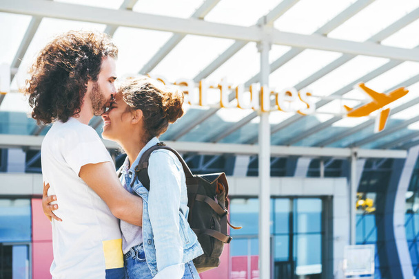 Emotional interracial couple meeting at the airport - Photo, Image