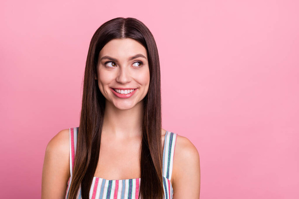 Photo of young attractive woman happy positive smile dream think look empty space isolated over pink color background - Zdjęcie, obraz