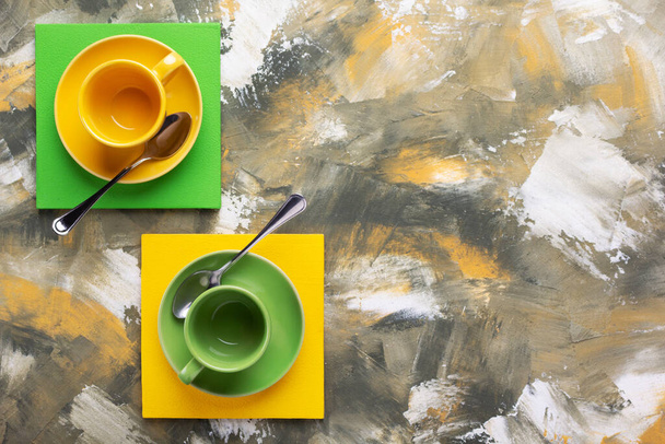 Empty cup of coffee and spoon at colorful abstract background texture. Coffee break time concept - Foto, afbeelding