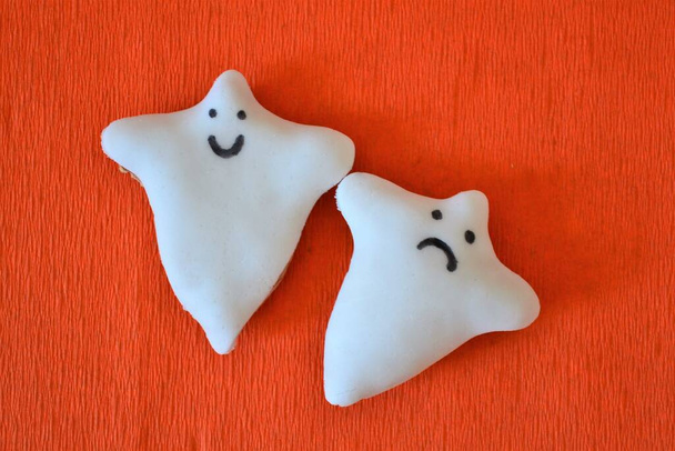 Halloween cookies in ghost shape on orange background - Photo, image
