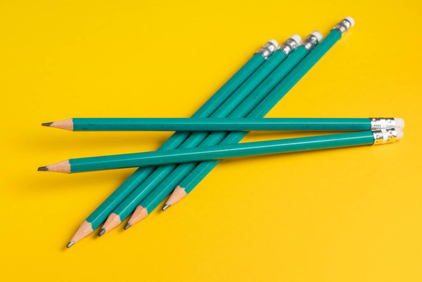 Pencils isolated on yellow background. - Fotoğraf, Görsel