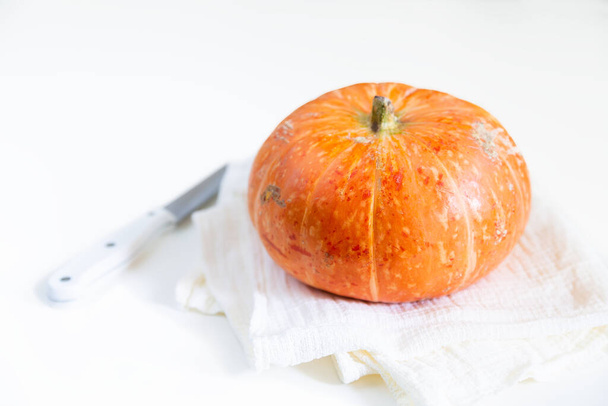 Pumpkin on a white towel. Isolated. Place for text. Selective focus, close-up. - Foto, Imagem