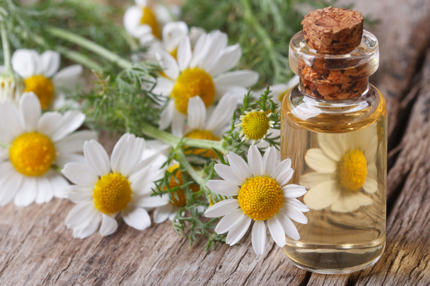 oil of chamomile flowers in a glass bottle macro - Photo, Image