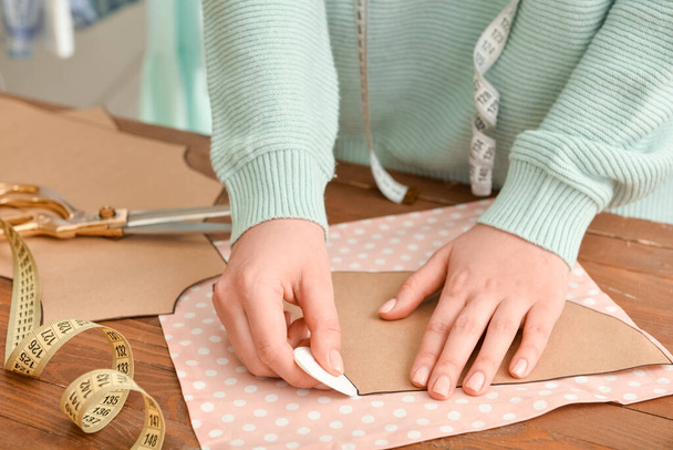 Young woman working with sewing pattern in studio - Photo, Image