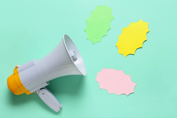 Modern megaphone and speech bubbles on color background - Photo, Image