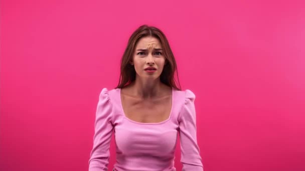 elégedetlen nő bemutató stop gesztus elszigetelt rózsaszín - Felvétel, videó