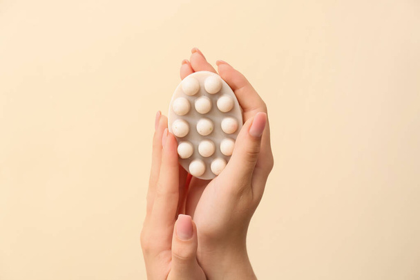 Female hands with massage soap bar on color background - Photo, Image