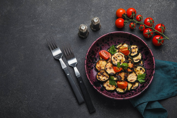 Composition with tasty grilled zucchini on dark background - Фото, изображение